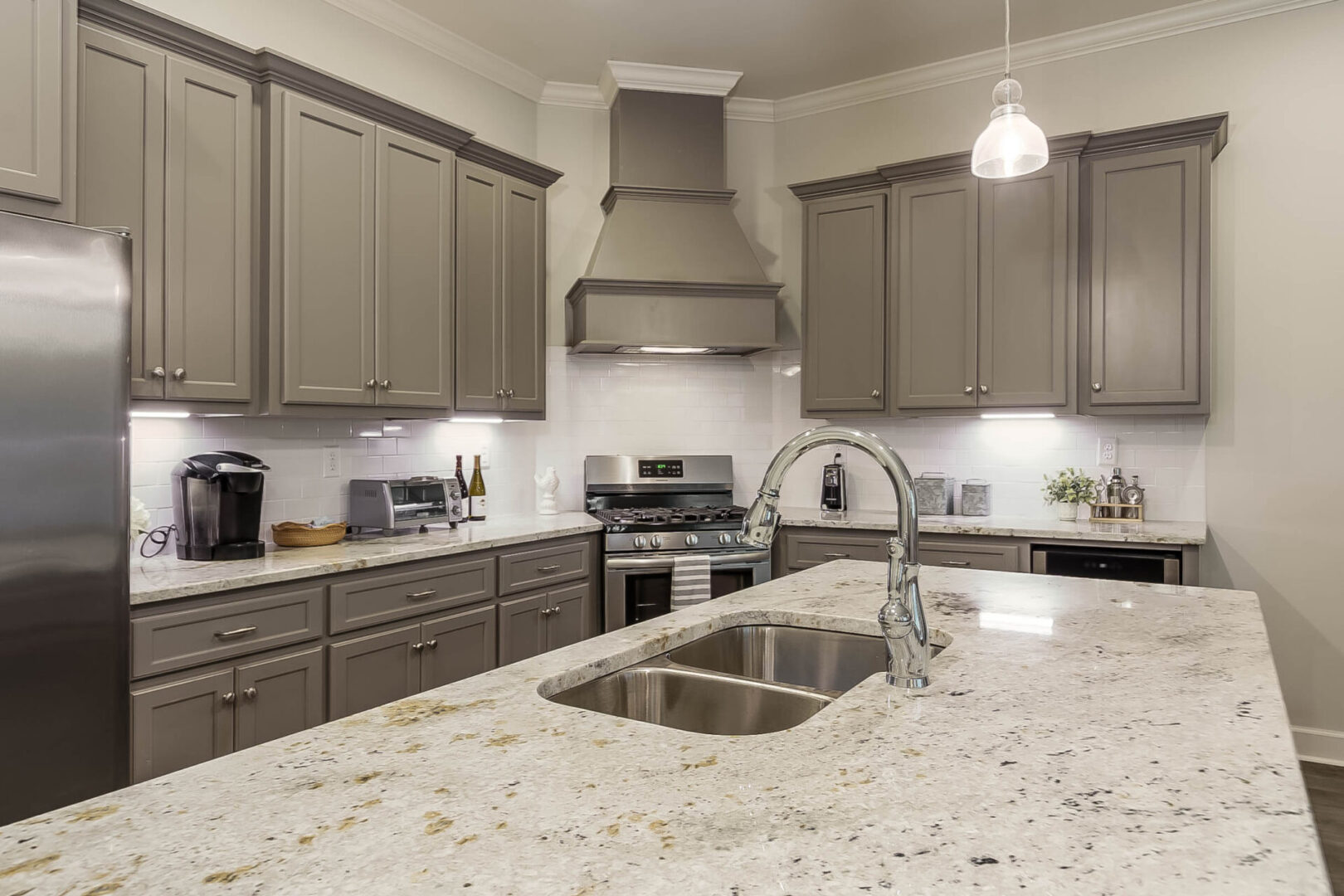 A kitchen area with marble countertops